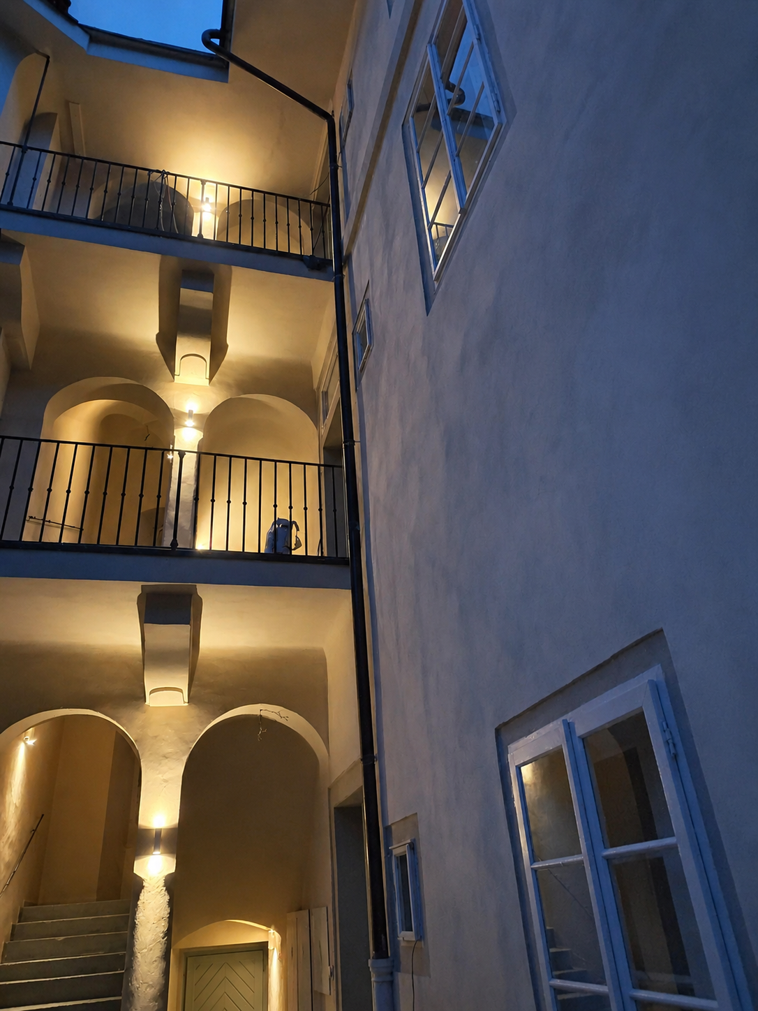 Courtyard staircase and galleries at dusk